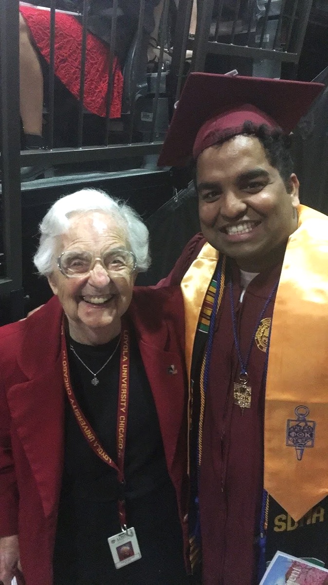 Sai Cheekireddy in a maroon graduation gown and cap