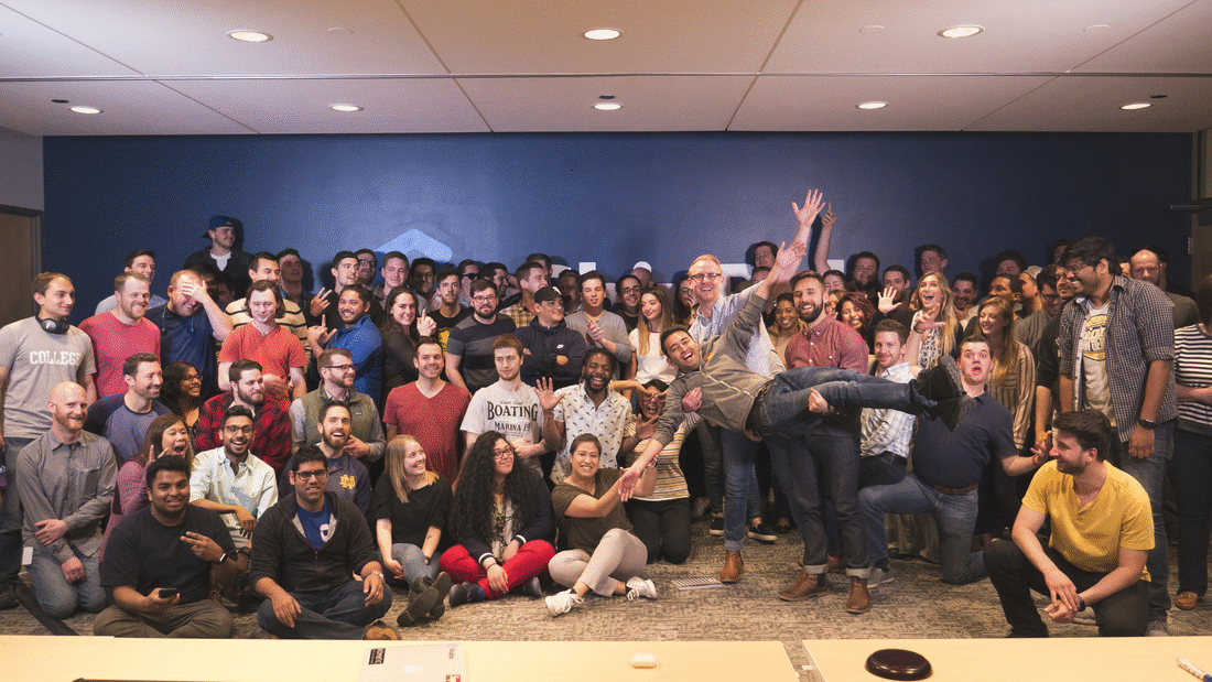 A large group gathered indoors at a learning event