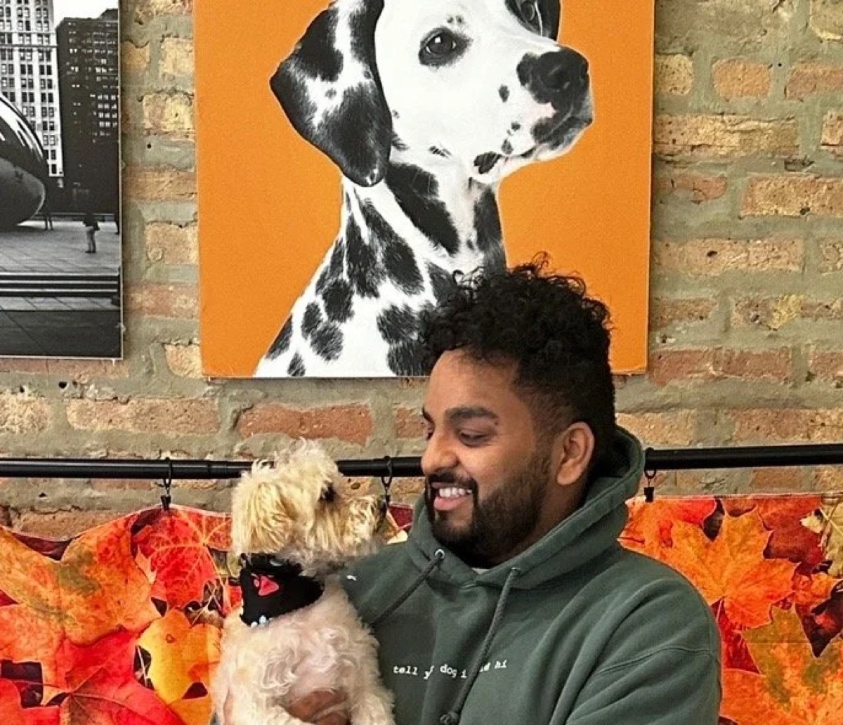 Sai Cheekireddy smiling while holding a small dog
